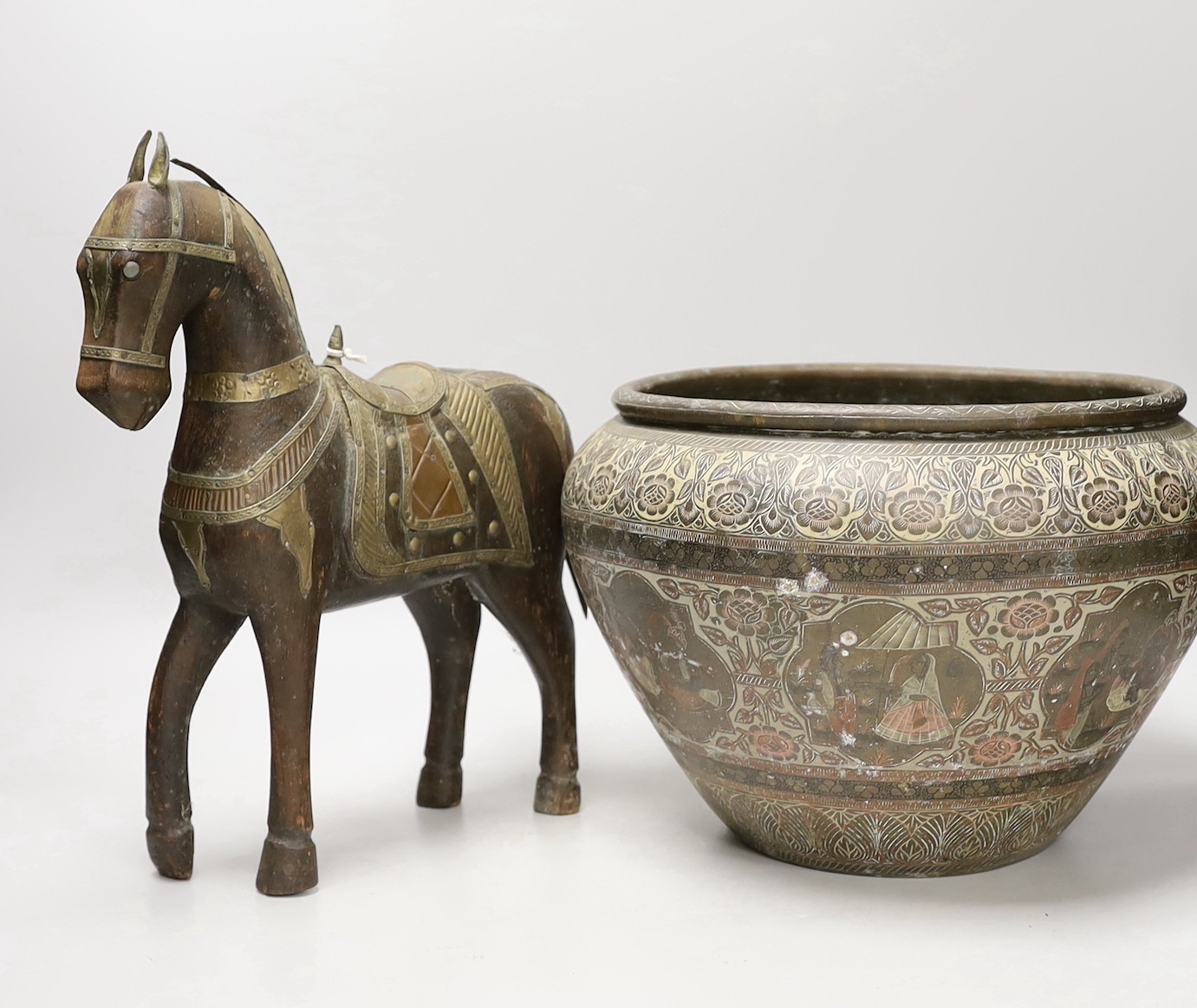 An Indian engraved brass jardiniere and brass-mounted wood horse, 31cm tall
